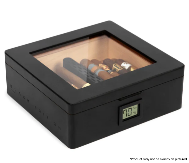 Introducing the black MAG humidor by Klaro, featuring a one-of-a-kind matte black textured finish, blacked-out metal hardware, and unique black stenciling on the sides. The MAG includes our newest humidity technology, the Hydro Channel, the easiest, most economical, and most effective humidification system out there. It takes up only one cigar width of space while creating the perfect cigar-storing environment. The base is curved so that you can stack cigars next to the tube. It comes equipped with our hype