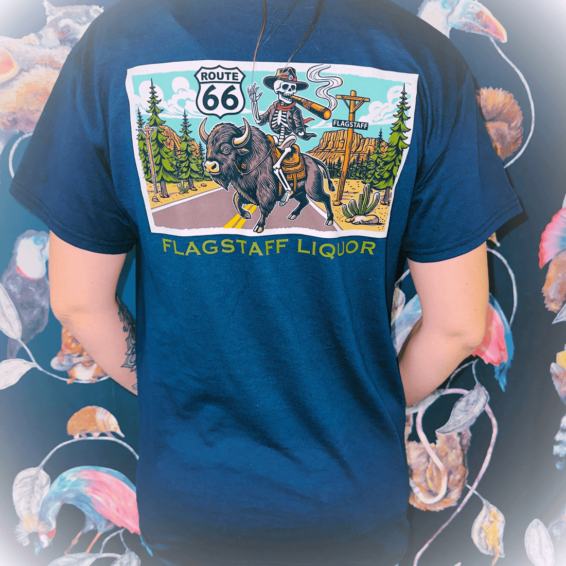 Back view of Flagstaff Liquor Buffalo Skeleton T-Shirt featuring Route 66 design, modeled by individual. Limited edition merch.